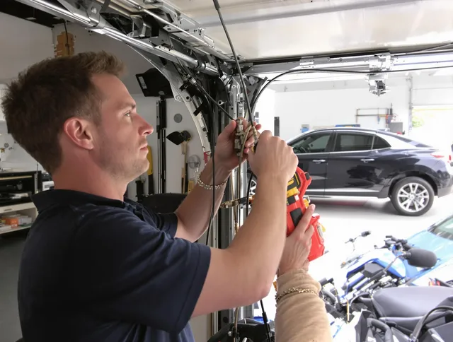 Norwich Garage Door Repair safety certified technician performing cable replacement in Norwich